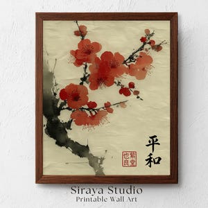 May include: A framed wall art print featuring a watercolor painting of vibrant red plum blossoms on a dark, ink-washed branch against a textured cream background. The artwork includes black Japanese calligraphy characters and a red square seal stamp.