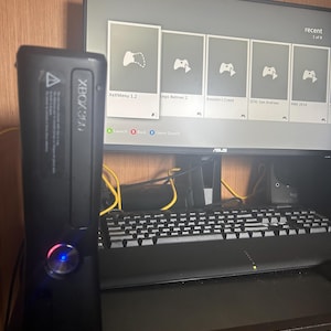 May include: A set of three ceramic mugs with a speckled, matte finish. The mugs are in shades of cream, light brown, and dark brown. Each mug has a simple, minimalist design and a rounded handle.