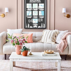 May include: A black framed wall poster titled Marathon Majors Bucket List featuring seven map squares for Tokyo, Boston, London, New York, Berlin, Chicago, and Sydney, with white skyline silhouettes at the bottom and blank date and time fields.