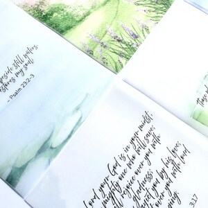 May include: A collection of watercolor art cards with inspirational quotes and Bible verses. The cards feature soft pastel colors and floral illustrations. The text includes verses from Matthew, Psalm, and Zephaniah.