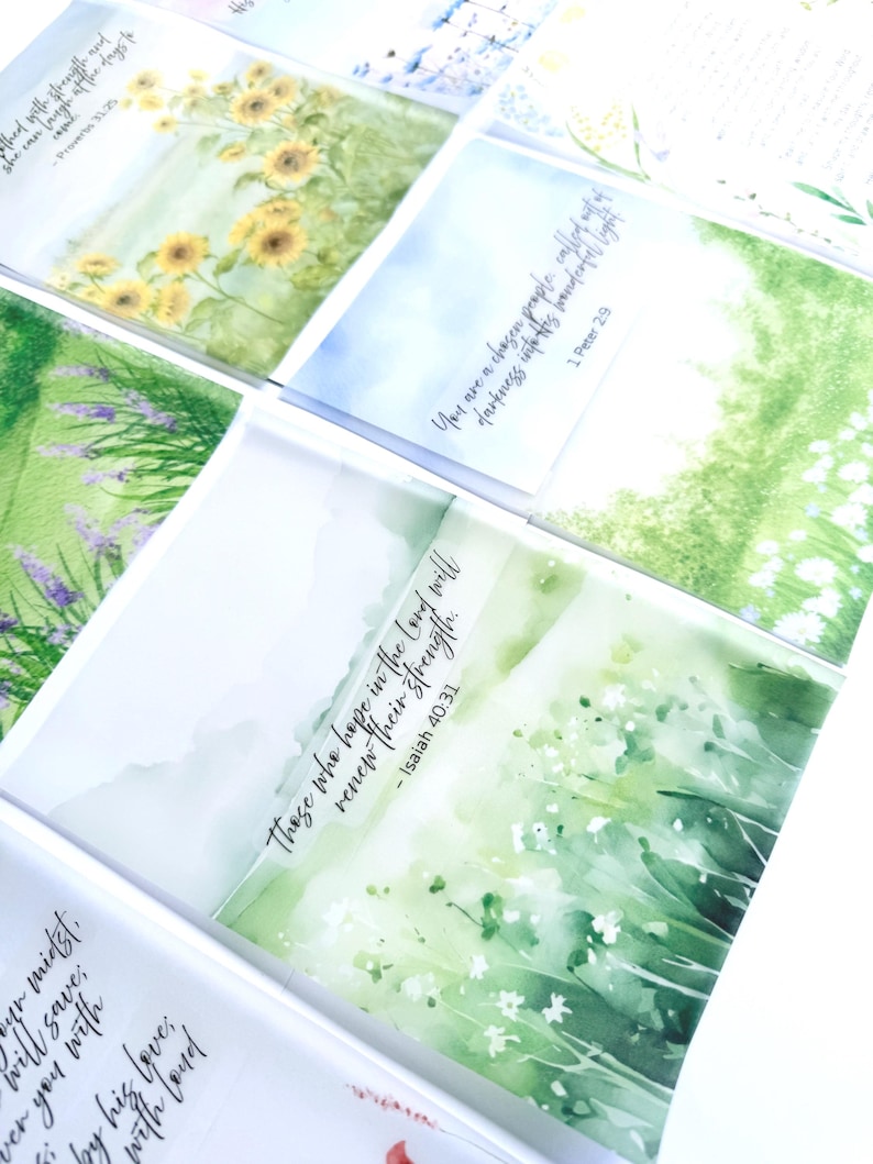 May include: A collection of watercolor art cards featuring nature scenes and inspirational quotes. The cards display images of sunflowers, lavender, and fields with text from the Bible. The cards are in a variety of colors, including green, yellow, and purple.