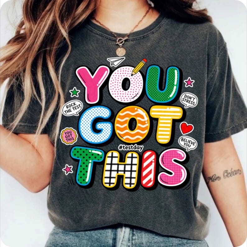 May include: A white ceramic mug with a black handle and the text "But First, Coffee" in a black, handwritten-style font. The mug is on a white surface.