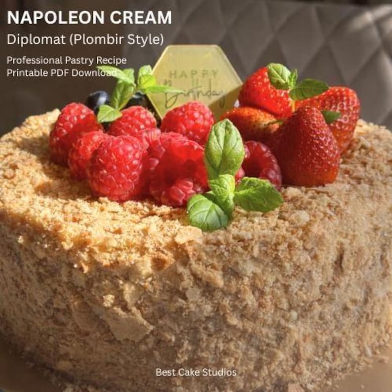 May include: A layered Napoleon cake, topped with fresh raspberries, strawberries, blueberries, and mint leaves. A gold hexagon-shaped sign that says "Happy Birthday" is placed on top. The cake is a professional pastry recipe.