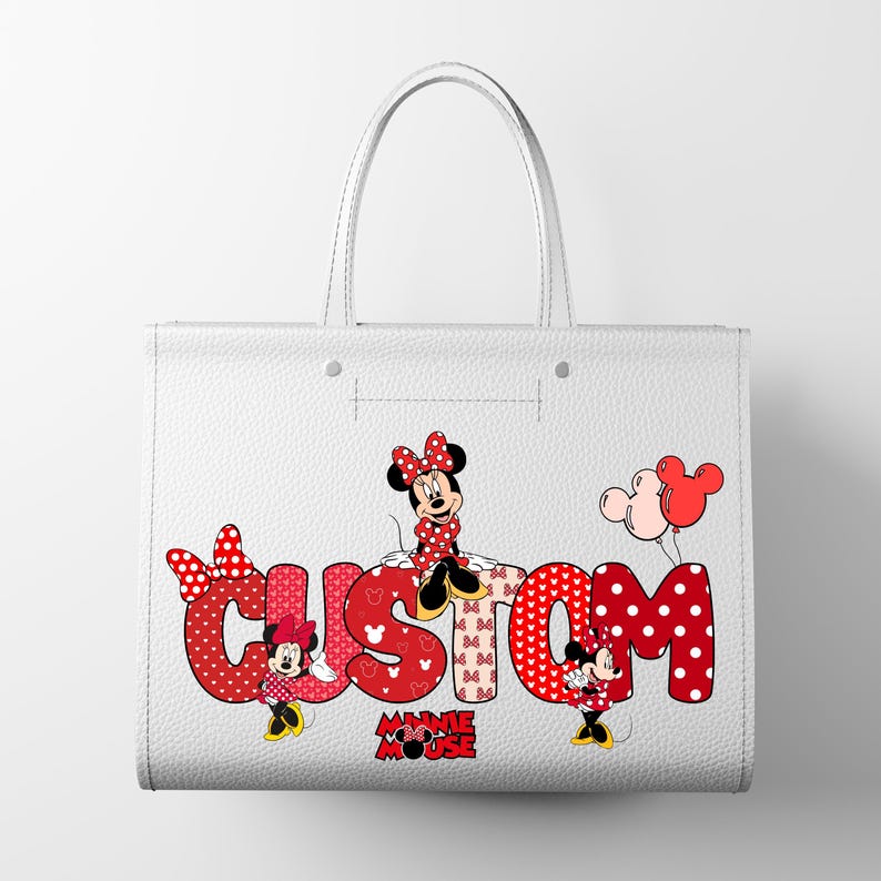 May include: A white tote bag featuring the word CUSTOM in large red polka-dot letters. Minnie Mouse characters are positioned around the text, with red and pink balloons floating above. The design includes small red bow icons and the text MINNIE MOUSE.