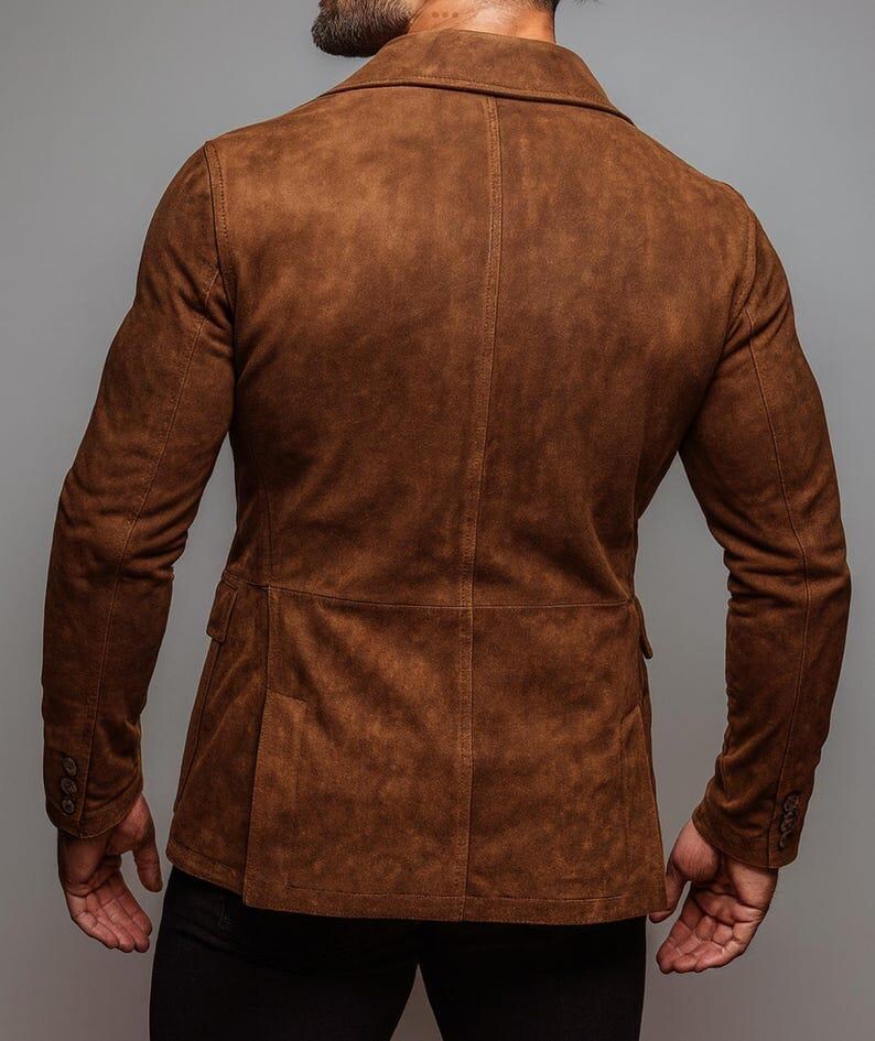 May include: A brown suede blazer with a classic two-button closure and notched lapels. The jacket features two front pockets and buttoned cuffs. The back view showcases the tailored fit and rich color of the garment.