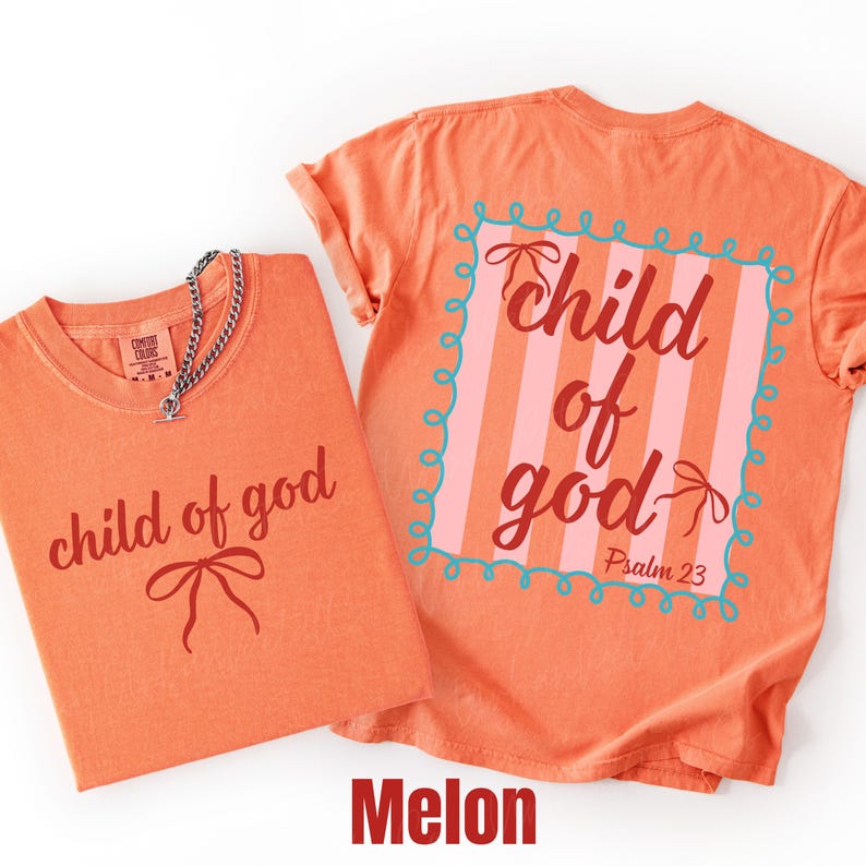 May include: Two melon-colored t-shirts with the text "child of god" in a script font. One shirt has the text and a bow graphic, the other has the text inside a pink and blue frame. A silver chain necklace is on one shirt.