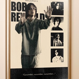 May include: A framed poster featuring Lewis Pullman as Bob Reynolds. The design includes a large central image of a person with hands raised, three smaller inset photos, and the text "lewis pullman is BOB REYNOLDS" with "Cucumber, cucumber, cucumber..." at the bottom.