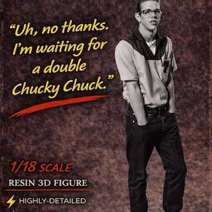 May include: A white ceramic mug with a black handle and the text "But First, Coffee" in a black, bold font. The mug is on a white surface.