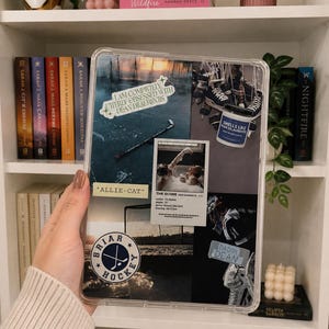 May include: A clear tablet case featuring a collage of hockey-themed imagery, including a hockey stick on ice, a goal net, skates, and stickers with text reading "I am completely utterly obsessed with Dean DiLaurentis," "Allie-Cat," and "Briar Hockey."