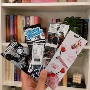 May include: Four rectangular paper bookmarks featuring collage-style designs. One displays hockey imagery with the text 'I'm in love with fictional hockey boys'. Another shows a receipt graphic with 'Hockey Romance'. Others feature photo prints, text, and raspberry illustrations.
