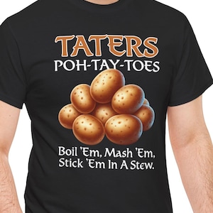 Op de afbeelding: Een zwart T-shirt met korte mouwen en een afbeelding van een hoop bruine aardappelen. De tekst luidt bovenaan TATERS POH-TAY-TOES en onderaan Boil 'Em, Mash 'Em, Stick 'Em In A Stew. in witte en oranje letters.