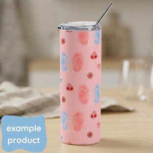 May include: A pink tumbler with a lid and a silver straw. The tumbler features a pattern of seahorses, cherries, and floral accents. The text "example product" is on a blue label.