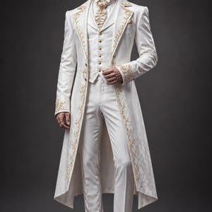 May include: A white long-coat suit featuring a vest with gold buttons, a matching cravat, and gold floral embroidery along the lapels and cuffs. The ensemble includes white trousers and white dress shoes with gold-toned accents on the toes.