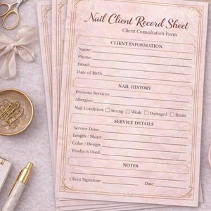 May include: A stack of pink Nail Client Record Sheets with gold decorative accents. The sheets include sections for client information, nail history, service details, and notes. Other items include a gold pen, scissors, and a small bowl with gold paper clips.