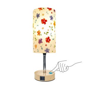 May include: A cylindrical table lamp with a floral pattern lampshade. The shade features red, purple, orange, and yellow flowers on a cream background. The lamp has a silver stem and a wooden base with a USB port and a touch-sensitive power button.