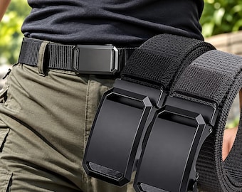 May include: A black nylon tactical belt featuring a rectangular matte black buckle with a geometric design. The belt is shown worn around the waist and held in the hand, displaying the durable woven texture of the strap and the solid metal buckle.