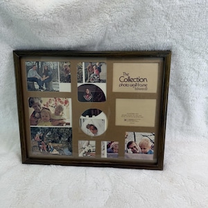 May include: A rectangular dark wood photo wall frame with multiple openings for various photograph sizes. The frame includes a tan mat board with the printed text The Collection photo wall frame by Intercraft and several family photographs.