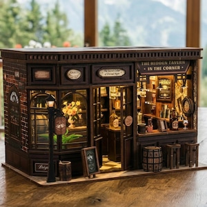 May include: A miniature wooden tavern model with intricate details. The model features a brick facade, large windows, and a sign that reads "The Hidden Tavern in the Corner." Inside, there are miniature bottles, bar stools, and a dartboard. A small sign reads "Whiskey."
