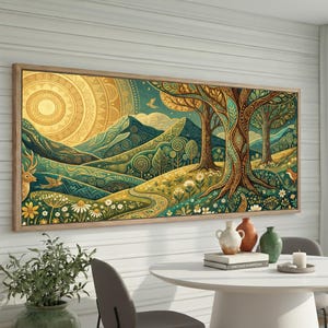 May include: A framed landscape art print depicting a stylized forest scene with a large sun, mountains, and trees. The artwork uses greens, yellows, and browns, with a deer and birds. The print is displayed above a white table with vases.