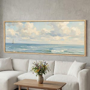 Peut inclure: Peinture de paysage encadrée représentant une scène maritime avec un voilier sur l'océan sous un ciel nuageux. L'œuvre est dans un cadre rectangulaire en bois clair, idéale pour la décoration intérieure.