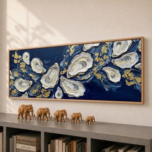 May include: A rectangular wall art piece featuring a textured oil painting of white and cream oyster shells against a deep navy blue background, accented with scattered gold leaf flakes, all enclosed within a light-toned wooden frame.