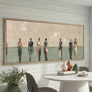 May include: Abstract painting featuring a row of silhouetted figures in neutral tones. The artwork has a textured background with a light brown sky and a green ground. The figures are painted in shades of black, gray, and orange, framed in a light wood.