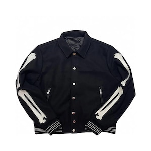 May include: Black jacket with white bone design on the sleeves. The jacket has a button-up front, two zippered pockets, and a ribbed hem with white stripes. A unique and edgy outerwear piece.