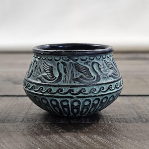 May include: A set of three ceramic mugs with a speckled, matte finish. The mugs are in shades of cream, light gray, and dark gray. Each mug has a simple, minimalist design and a rounded handle.