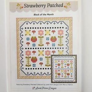 May include: A printed paper featuring a quilt design titled "Strawberry Patched." The design includes strawberries, flowers, and mushrooms in a repeating pattern. The text "Block of the Month" is also visible. The paper is from Lamb Farm Designs.