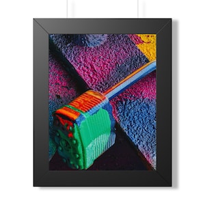 May include: A framed art print featuring a colorful, close-up view of a padlock. The padlock is painted in shades of green, orange, and blue, with a rainbow-colored measuring tape extending from it. The background is a textured surface with vibrant pink, blue, and yellow paint.