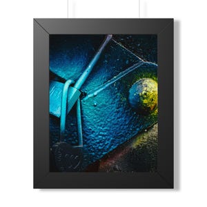 May include: Framed art print featuring a close-up of a textured, blue-painted surface with a heart-shaped lock. The lock is black with the words "LOVE IS" and two hearts. The artwork has a graffiti-like aesthetic.