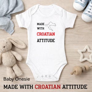 Könnte beinhalten: Eine weiße Keramik-Tasse mit schwarzem Henkel und dem Text "But First, Coffee" in schwarzer, handschriftlicher Schrift. Die Tasse steht auf einer weißen Oberfläche.