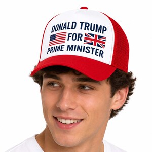 May include: A red and white trucker hat featuring the text DONALD TRUMP FOR PRIME MINISTER in dark blue lettering. The design includes a small American flag and a Union Jack flag positioned between the words on the white front panel.