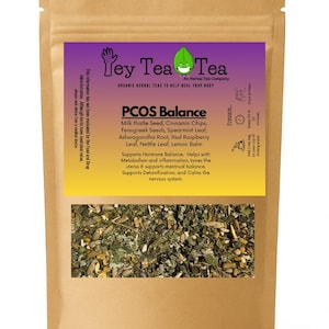 May include: A brown paper bag of "Ley Tea Tea" PCOS Balance tea. The label is purple and yellow with text that lists ingredients like milk thistle seed and spearmint leaf. The bag contains dried herbs.