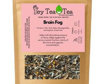 May include: A brown paper bag of "Yey Tea Tea" brand herbal tea, labeled "Brain Fog." The pink label lists ingredients like turmeric and lemongrass. The tea is designed to help with memory and focus. The bottom of the bag shows the tea leaves.