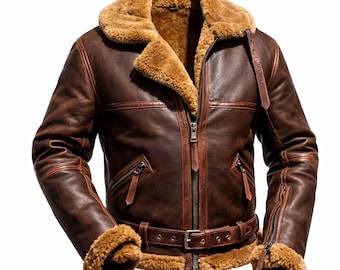May include: A brown leather jacket with a shearling collar and lining. The jacket features a zip-up front, two zippered pockets, and a belt at the waist. The sleeves have zippered cuffs and shearling trim. A classic bomber jacket style.