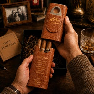 May include: A tan textured leather cigar case with a metal cutter integrated into the top flap. The case features an engraved mountain logo with the name TIMOTHY and a personalised message reading To the BEST DAD in the world, thank you for your love, guidance, and unwavering support. We love you! Love, Claire, Elias, Annalise & Gannon.
