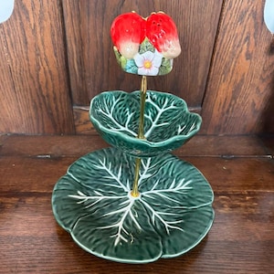 May include: A white ceramic mug with a black handle and the text "But First, Coffee" in a handwritten style. The mug is on a white surface. The mug is approximately 4 inches tall.