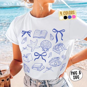 May include: White t-shirt featuring blue line art of seashells, books, and bows. The top has a crew neck and short sleeves. A colour palette of white, black, blue, and pink is also shown. The words "PNG & SVG" are in the lower right corner of the image.