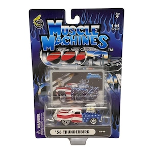 May include: A white ceramic mug with a black handle and the text "But First, Coffee" in a bold, black font. The mug is sitting on a wooden surface. The mug is approximately 4 inches tall.