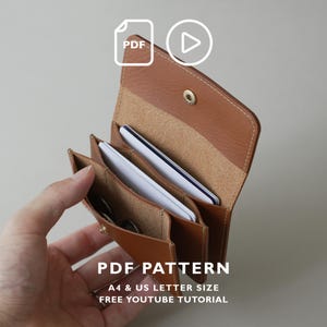 May include: A tan leather wallet with multiple interior compartments containing white cards and coins. The wallet features a gold-tone snap button closure and visible stitching. Text on the image reads PDF PATTERN A4 & US LETTER SIZE FREE YOUTUBE TUTORIAL.