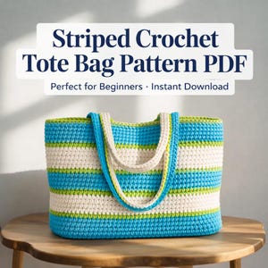 May include: A crocheted tote bag featuring blue, white, and green horizontal stripes. The bag has a rectangular form with a solid base and handles. The image text says "Striped Crochet Tote Bag Pattern PDF".
