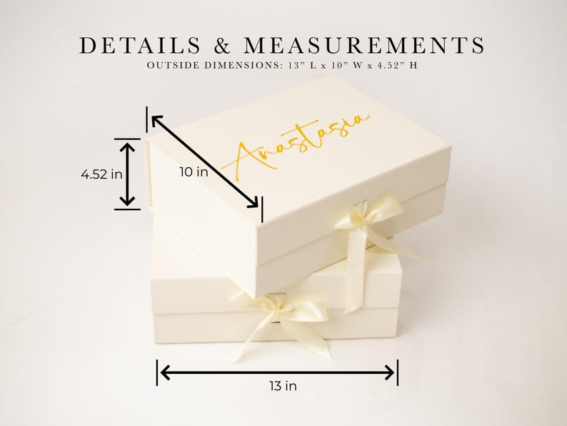 May include: A cream-coloured rectangular gift box with a gold script name Anastasia on the lid and a satin ribbon closure. The box measures 33.02 cm long, 25.4 cm wide, and 11.48 cm high, as indicated by the text and dimension lines.