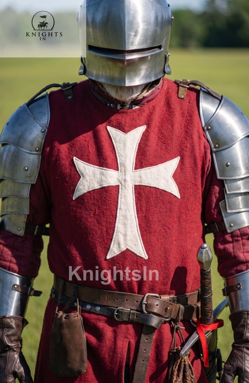 May include: A medieval knight's outfit, featuring a red tunic with a white cross emblem, metal armor, and a helmet. The image includes a sword and leather belt. The text "Knights In" is visible.