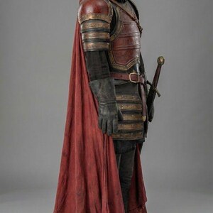 May include: A full suit of medieval armor, including a helmet, chest plate, and gauntlets. The armor is primarily dark red and gold, with a long red cape. A sword is sheathed at the waist. The image includes the text "KNIGHTS IN".
