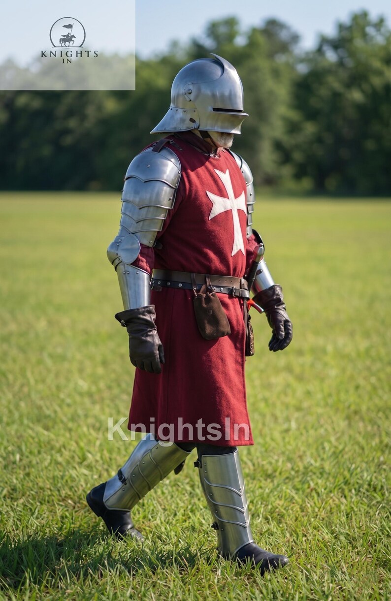 May include: A person in medieval armor, including a helmet, shoulder and arm protection, and leg guards, walks across a grassy field. The red tunic features a white cross. The image includes the text "Knights In".
