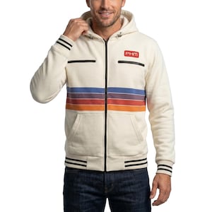 Puede incluir: Una sudadera con capucha y cremallera de color crema que presenta un patrón de rayas horizontales multicolores en azul, morado y naranja en el pecho. La prenda incluye una cremallera frontal negra, dos bolsillos en el pecho y puños a rayas.