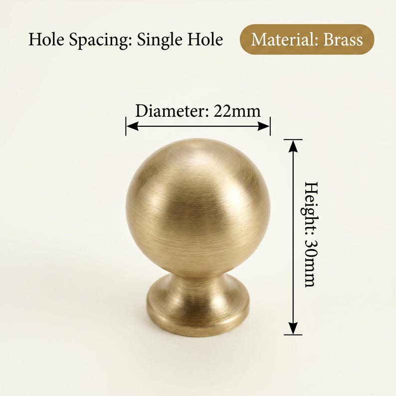 May include: A brass cabinet knob with a spherical design. The knob has a diameter of 22mm and a height of 30mm. The text on the image reads "Hole Spacing: Single Hole" and "Material: Brass".