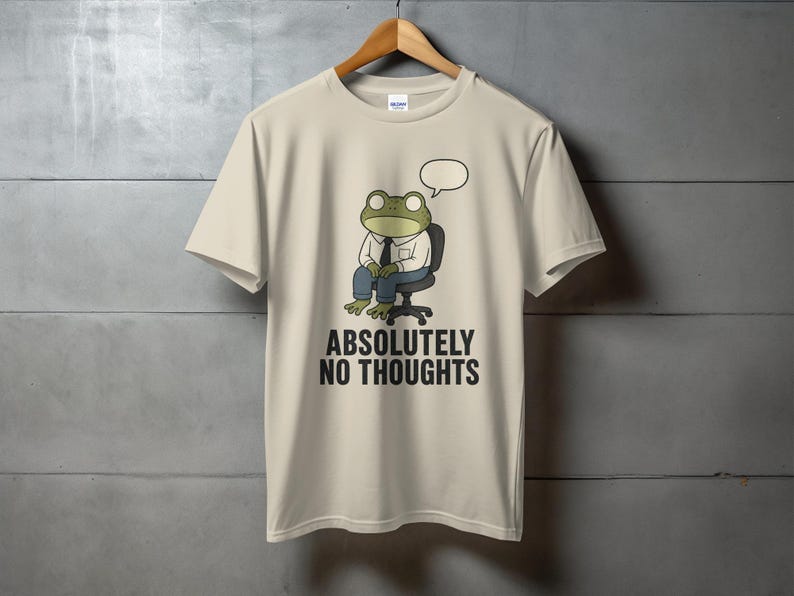 T-shirt with cartoon frog sitting in chair, text "ABSOLUTELY NO THOUGHTS".