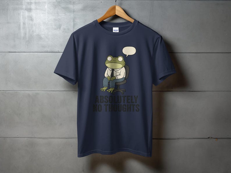 Dark blue t-shirt with a cartoon frog wearing a shirt and tie, sitting in a chair, with text "ABSOLUTELY NO THOUGHTS".